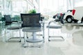 Inside car showroom interior with group of chairs and table Royalty Free Stock Photo
