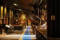 Inside the Catholic church is an altar with icons and lamps. organ, ancient decoration, Gothic, stained glass windows, columns. Royalty Free Stock Photo