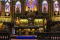 Inside the Catholic church is an altar with icons and lamps. organ, ancient decoration, Gothic, stained glass windows, columns. Royalty Free Stock Photo