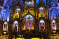 Inside the Catholic church is an altar with icons and lamps. organ, ancient decoration, Gothic, stained glass windows, columns. Royalty Free Stock Photo