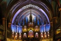 Inside the Catholic church is an altar with icons and lamps. organ, ancient decoration, Gothic, stained glass windows, columns. Royalty Free Stock Photo