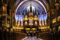 Inside the Catholic church is an altar with icons and lamps. organ, ancient decoration, Gothic, stained glass windows, columns. Royalty Free Stock Photo