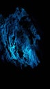 Inside of a cave lit up in blue light Royalty Free Stock Photo