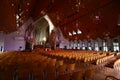 Seating area with wood seating under sloped ceiling on modern interior of Holy Trinity Cathedral, Parnell, Auckland, New Zealand