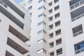 Inside corner of a multi-story residential building, close view of windows and balconies