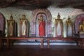 Inside of Dambulla cave temple. Standing Buddha statue