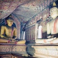 Inside of Dambulla cave temple. Statues of Buddha in ancient stone temple