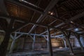 Inside dark abandoned ruined wooden decaying hangar with rotting columns