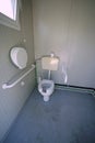 Inside the disabled bathroom with the special water closet Royalty Free Stock Photo