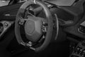 Inside driver seat of super car with steering wheel and modern features on dashboard Royalty Free Stock Photo