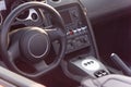 Inside driver seat of super car with steering wheel and modern features on dashboard Royalty Free Stock Photo