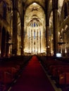 Inside empty church seats row red carpet indoor cathedral stones historic light altar shine religious Barcelona spain