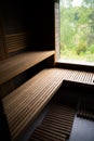 Inside of empty Finnish sauna room. Modern interior of wooden spa cabin with dry steam. Royalty Free Stock Photo