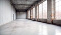 Inside of an empty, large warehouse building with concrete walls, floor and huge windows. Royalty Free Stock Photo