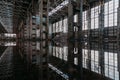 Inside of flooded dirty abandoned ruined industrial building with water reflection