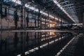 Inside of flooded dirty abandoned ruined industrial building with water reflection