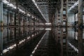 Inside of flooded dirty abandoned ruined industrial building with water reflection