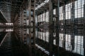 Inside of flooded dirty abandoned ruined industrial building with water reflection