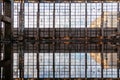 Inside of flooded dirty abandoned ruined industrial building with water reflection