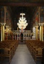 Inside The  Greek Orthodox Church with Big Chandelier and Empty Chairs Royalty Free Stock Photo