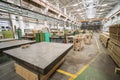 Inside interior factory workshop with stacks of wood for making molds and carpentry machine tools