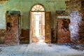 Inside interior of an old abandoned church in Latvia, Galgauska, entrance door and damaged brick wall Royalty Free Stock Photo