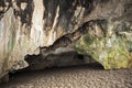 Inside a large cave in limestone crock on the beach. Grotto.