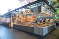 Inside market hall showing food court area with Cheese and More stand showing company logo, stall, signage and branding