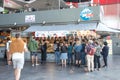 Inside market hall showing food court area with Fish and Chips stall with customers, sign, signage, logo and branding