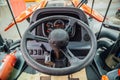 Inside modern agricultural tractor or harvester combine machine. Steering wheel. View from work place