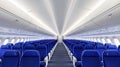 Inside a modern airplane, bright lights illuminate rows of blue seating, creating an inviting atmosphere for passengers Royalty Free Stock Photo