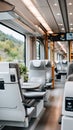 Inside a modern train, empty seats are lined up, offering a clean and comfortable space for passengers to enjoy their journey Royalty Free Stock Photo