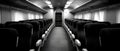 Inside a modern train, empty seats are lined up, offering a clean and comfortable space for passengers to enjoy their journey Royalty Free Stock Photo