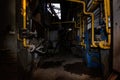 Inside old collapsed industrial building. Old rusty pipeline Royalty Free Stock Photo