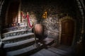 Inside of old creepy abandoned mansion. Staircase and colonnade. Dark castle stairs to the basement. Spooky dungeon stone stairs