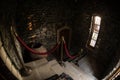 Inside of old creepy abandoned mansion. Staircase and colonnade. Dark castle stairs to the basement. Spooky dungeon stone stairs Royalty Free Stock Photo