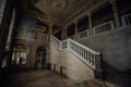 Inside of old creepy abandoned mansion. Staircase and colonnade