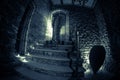 Inside of old creepy abandoned mansion. Staircase and colonnade. Silhouette of horror ghost standing on castle stairs to the basem