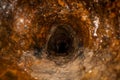 inside old dirty sewer line pipe. rusty casting iron drain tube Royalty Free Stock Photo