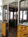 The inside of an old historic yellow tram with graffiti in Lisbon