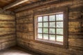 Inside of an old log home facing windows.