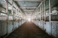 Inside old wooden stable or barn with horse boxes, tunnel or corridor view Royalty Free Stock Photo