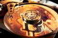 Open computer hard drive with the projected bitcoin symbol Royalty Free Stock Photo