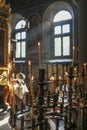Inside an orthodox church - an interior with lancet windows, tall stands, candels and a choir Royalty Free Stock Photo