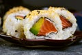 Inside out sushi california roll filed raw salmon fish, avocado, cream cheese and topped with sesame Royalty Free Stock Photo