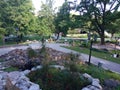 Inside of a park in Riga Lativa, with people walking or sitting on the grass