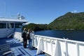 People admiring the beautiful blue ocean along the BC ferries inside passage route on the British Columbia coast , Canada.
