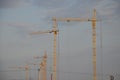 Inside place for many tall buildings under construction and cranes under a blue sky working on place with tall homes Royalty Free Stock Photo