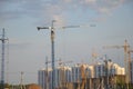 Inside place for many tall buildings under construction and cranes under a blue sky working on place with tall homes Royalty Free Stock Photo
