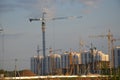 Inside place for many tall buildings under construction and cranes under a blue sky working on place with tall homes Royalty Free Stock Photo